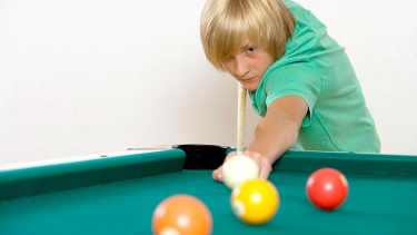 Junge spielt Billard
